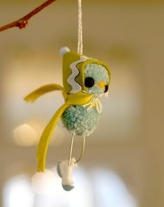 an ornament shaped like a bird hanging from a branch