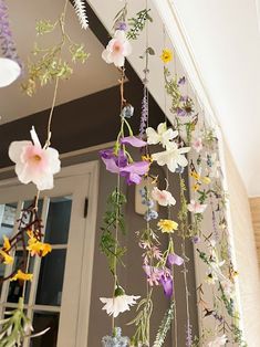 flowers hanging from the ceiling in front of a door