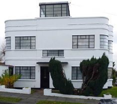 a large white building sitting on the side of a road