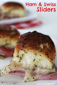 ham and swiss sliders on a white plate with pepper sprinkled crusts