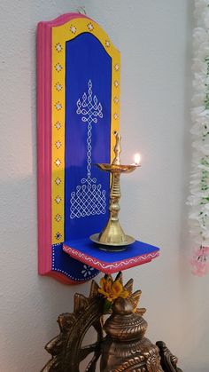 an ornate brass lamp on top of a blue shelf