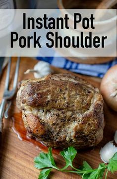 an instant pot pork shoulder on a cutting board with garlic and parsley next to it