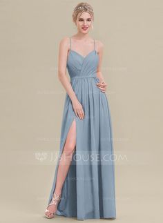 a woman wearing a long blue dress with a slit in the side and one leg