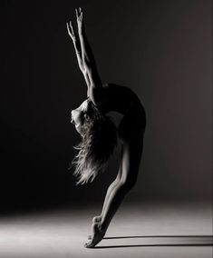 a woman is doing a handstand in the air with her legs spread out