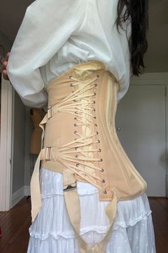 Amazing vintage triple fan corset. Labeled "Freeman Surgical Corset" with hooks and eye closures and lace up sides. There are ventilation flaps under each arm and elastic at the armpits and hips. Adjusts at sides with triple fan lacing. Has two very strong surgical steel boning rods in the back.  Good vintage condition- some discoloration and fading.  This item has been hand washed. There is some fraying on straps as well as discolorations, pictured.  No sizing tag, estimated S/M. Please see mea Fan Lacing Corset, Fitted Vintage Corset For Festivals, Vintage Fitted Corset For Festival, Vintage Underbust Corset Belt For Costume, Vintage Beige Overbust Corset, Beige Vintage Overbust Corset, Vintage Underbust Corset Belt With Historical Design, Vintage Overbust Corset Dress With Boning, Vintage Underbust Corset Dress For Festival