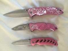 three pink knives with floral designs on them