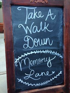 a chalkboard sign that says take a walk down memory lane