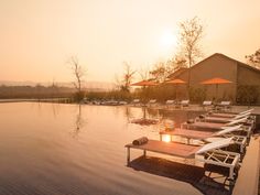 a row of lounge chairs sitting on top of a swimming pool