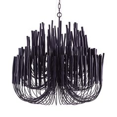 a black chandelier hanging from a chain with lots of sticks sticking out of it