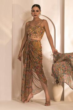 Yellow and multi colored printed cape with hand embellishments. Comes with coordinating draped dhoti skirt and hand embellished bustier. - Aza Fashions Festive Bohemian Pre-draped Saree, Bohemian Pre-draped Georgette Saree For Designer Wear, Bohemian Georgette Pre-draped Saree For Festive Occasions, Bohemian Fitted Sharara With Sheer Dupatta, Bohemian Pre-draped Saree For Navratri, Bohemian Style Pre-draped Georgette Saree With Unstitched Blouse, Bohemian Multicolor Pre-draped Saree With Unstitched Blouse, Bohemian Georgette Pre-draped Saree For Diwali, Fitted Silk Bohemian Sharara