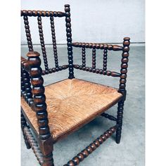 an old wooden chair sitting on top of a cement floor