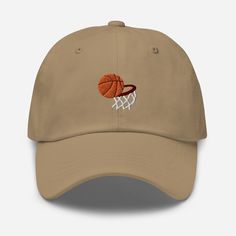 Elevate your sports style with the Basketball Embroidered Dad Hat, where athletic design meets comfort and versatility. 🏀 🧵 Product Details: Material: Crafted from 100% cotton twill, ensuring a soft and comfortable feel. * Design: Showcases a bold basketball embroidered motif, expressing your love for the game and athletic spirit. * Style: Features an unstructured, 6-panel, low-profile design, offering a laid-back and sporty aesthetic. * Ventilation: Designed with 6 embroidered eyelets to prov Casual Cotton Sports Baseball Cap, Cotton Snapback Hat With Embroidered Logo, Cotton Snapback Hat With Embroidered Logo Visor, Cotton Snapback Visor Hat With Embroidered Logo, Cotton Visor Snapback Hat With Embroidered Logo, Sporty Cotton Dad Hat With Flat Bill, Breathable Curved Bill Dad Hat For Sports, Embroidered Baseball Cap With Visor For Streetwear, Casual Baseball Cap With Letter Embroidery And Flat Bill