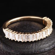 a gold ring with baguettes on top of it