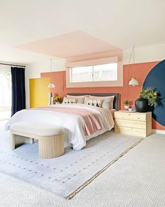 a bedroom with pink, yellow and blue colors on the walls is pictured in this image