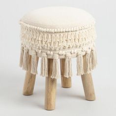 small stool with tassels and wooden legs in white color for decoration or furniture