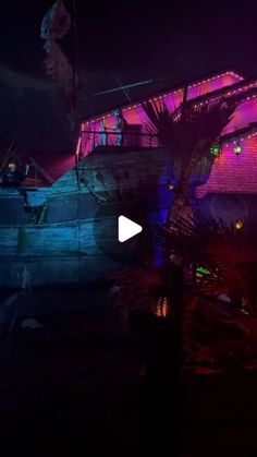 an old boat is lit up with colorful lights