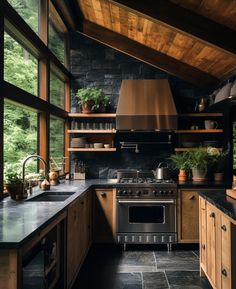 a kitchen with an oven, stove and sink inside of it next to large windows