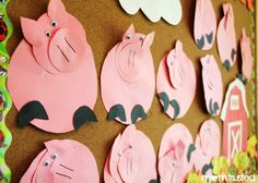 a bulletin board with pigs cut out on it's sides and flowers in the background