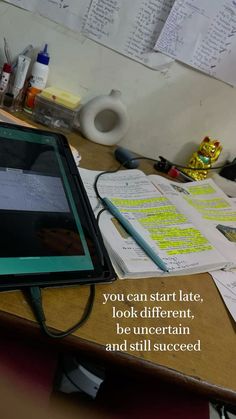 there is a tablet on the desk with notes all over it