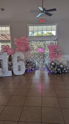 a room with balloons and letters on the floor