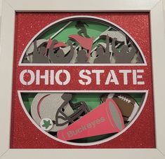 a red and white frame with the word ohio state surrounded by cutouts of sports equipment