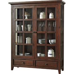 a wooden china cabinet with glass doors and shelves filled with dishes, cups, and glasses