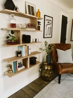 a living room filled with lots of furniture and bookshelves on top of shelves