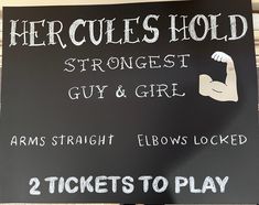 a sign that says hercules hold and two tickets to play in front of the sign