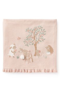 a pink blanket with animals on it and a tree in the middle, next to a ladder