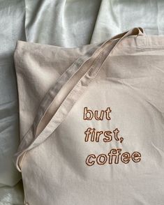 a white bag with the words but first, coffee written in brown ink on it