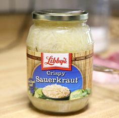 a glass jar filled with rice sitting on top of a wooden table