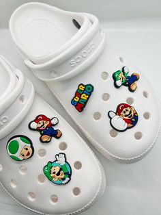 Set of 6 Super Mario Charms for Crocs *Speciially designed for clog shoes, adding a fun touch to your favorite footwear *Easy to attach and remove, allowing you to personalize your clogs with different charms for different occasions *Fits all sizes of Crocs and other clogs. *Packed in resealable gift pouches, our charms make a perfect gift and are great as party favors for birthdays and other events ( In case you're interested in placing an order of more than three packs, please get in touch wit Mario Gifts, Mario Party Favors, Super Mario Party Favors, Super Mario Gifts, Charms For Crocs, Super Mario Party, Clog Shoes, Mario Party, Croc Charms