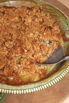 a dish with some food in it and a spoon on the plate next to it