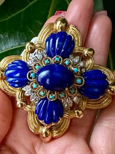 This exquisite brooch features a sophisticated design combining carved lapis lazuli, diamonds, and turquoise to create a stunning piece. Made of solid 18k yellow gold, this vintage jewelry is in excellent condition without any chips. A must-have for any collector of fine jewelry. Vintage Estate Jewelry Carved Lapis Lazuli Turquoise & Diamonds 18k Yellow Gold 74.7 Grams Brooch or Pendent Preowned Excellent Condition Lapis Jewelry, Sophisticated Design, Jewelry Vintage, Estate Jewelry, Lapis Lazuli, Brooch Pin, Brooches, Vintage Jewelry, Fine Jewelry