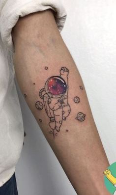 an astronaut tattoo on the arm