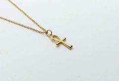 Ankh necklace ,Egyptian ankh jewelry, ankh gold necklace, dainty necklace gold , 24k gold plated necklace, Egyptian cross of life The ankh or key of life is an ancient Egyptian hieroglyphic symbol that was most commonly used in writing and in Egyptian art to represent the word for life and by extension as a symbol of life itself. These beautiful ankh gold necklaces are so simple minimalistic and represent so much in a simple teardrop cross. Made from 24k plated stainless steel designed with the Gold Ankh Necklace With Adjustable Chain, Gold Adjustable Minimalist Cross Necklace, Spiritual Ankh Necklace With Adjustable Chain, Gold Ankh Necklace Gift, Gold Ankh Necklace For Gift, Handmade Ankh Gold Necklace, Handmade Gold Ankh Necklace, Gold Ankh Cross Necklace Gift, Ankh Necklace With Adjustable Chain For Gift