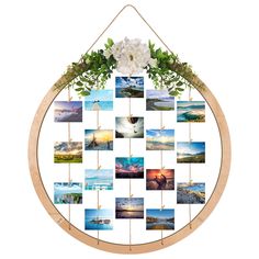 a wooden circle with pictures hanging from it's sides and flowers on each side