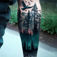 a man's leg with trees and birds on it