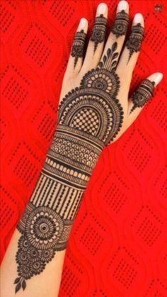 a woman's hand is decorated with hennap and intricate designs on it