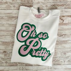 a white t - shirt with green and pink lettering that says, oh so pretty