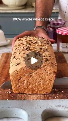 a loaf of bread is being sliced on a cutting board