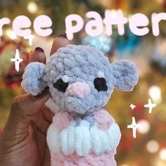 a hand holding a small stuffed animal in front of a christmas tree with the words free pattern above it