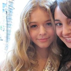 two young women are posing for the camera