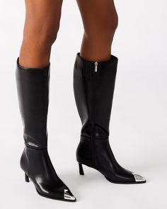 The LUCIANA is a stylish and sophisticated knee-high boot with a sleek kitten heel and pointed toe. Its silver toe cap adds a touch of elegance to any outfit. Expertly crafted for comfort, these boots are perfect for any occasion. 2.25 inch heel height Size 6 measurements: 14 inch shaft circumference, 15.25 inch shaft height Size 8 measurements: 15 inch shaft circumference, 16.25 inch shaft height Size 10 measurements: 16 inch shaft circumference, 17.25 inch shaft height Vegan leather upper mate Elegant Silver Knee-high Boots, Elegant Silver Heeled Boots For Fall, Fitted Heeled Boots With Metal Feet, Silver Knee-high Boots With Pointed Toe For Fall, Silver Fitted Knee-high Boots, Elegant Fitted Silver Heeled Boots, Silver Fitted Knee-high Boots For Fall, Fitted Silver Knee-high Boots For Fall, Leather Socks