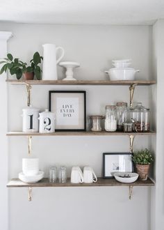 the shelves are filled with various items such as cups, vases and other things