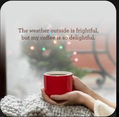 a person holding a red coffee cup with the words, the weather outside is frightened, but my coffee is so delightful