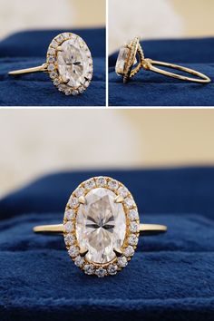 an oval cut diamond surrounded by smaller round diamonds sits on a blue velvet surface and is flanked by two gold - plated rings