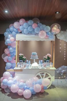 a table with balloons and cake on it