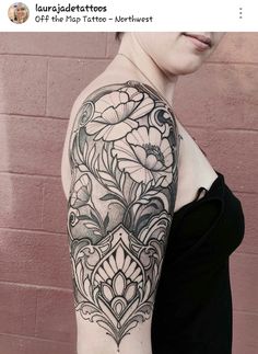 a woman with a black and white flower tattoo on her arm, standing in front of a brick wall