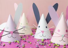 paper hats with bunny ears on them and sprinkles all over the ground